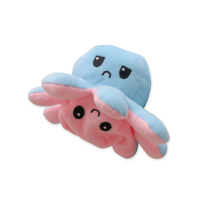 A large reversible octopus plush toy in blue and pink, featuring cute expressive faces. It has a simple logo.