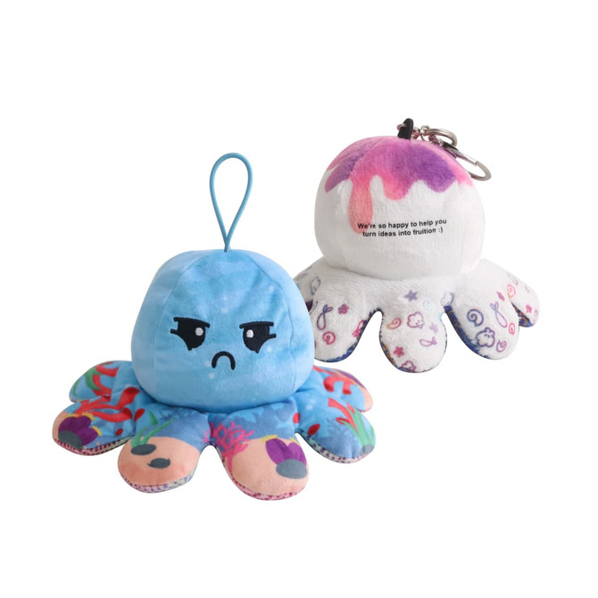 A small reversible octopus plush toy featuring blue on one side, with an angry face, and white on the other with a playful design.