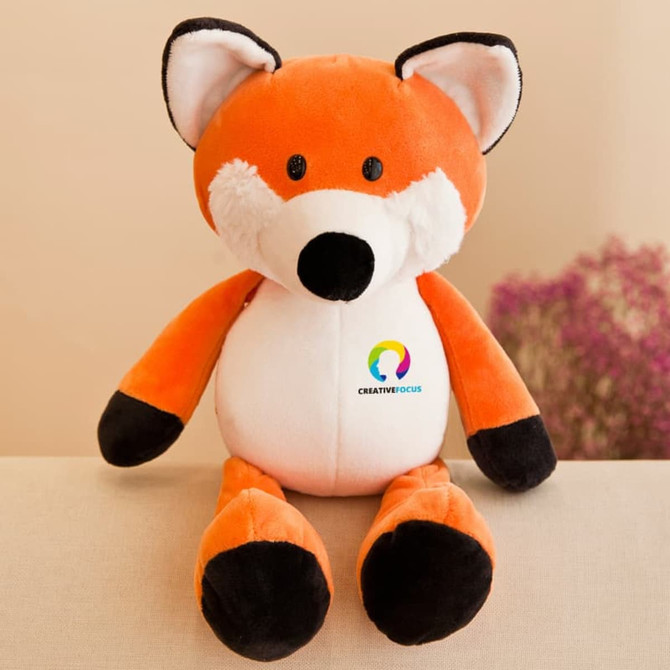An orange and white fox plush toy with black details and a branding logo on its chest.