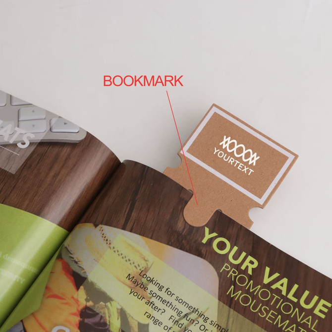 A brown bookmark with a tab, placed within the pages of a magazine or brochure, featuring a logo.