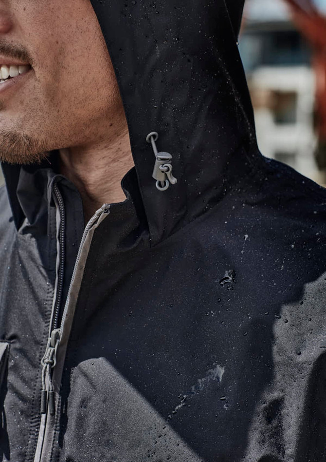 A black unisex packable rain jacket with a hood, featuring water droplets on its surface and a logo detail.