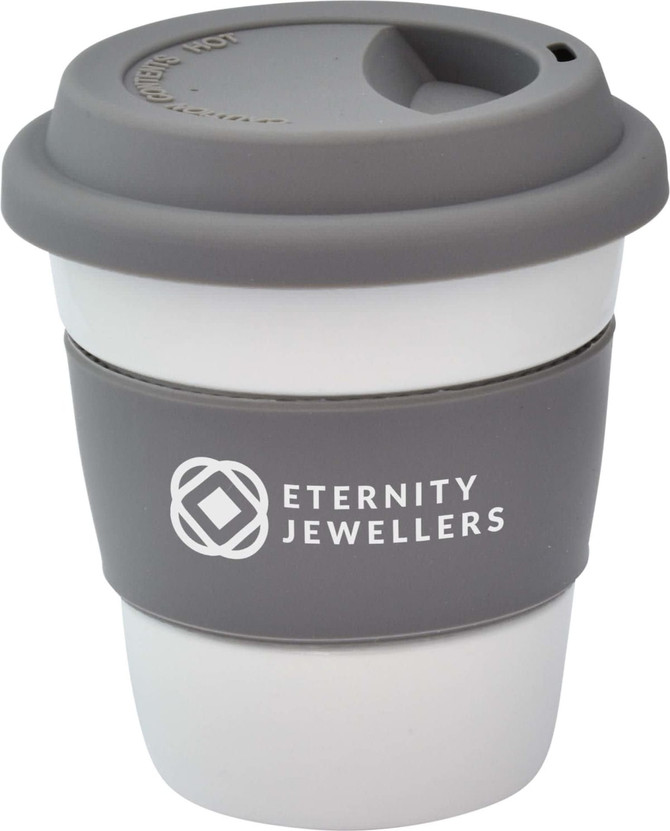 A reusable ceramic mug in white and grey, featuring a silicone lid and grip band, with a logo on the side.