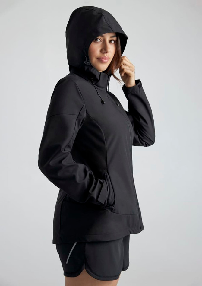 A black women's jacket with a hood, featuring a front zip and a fitted design. It includes a logo on the side.
