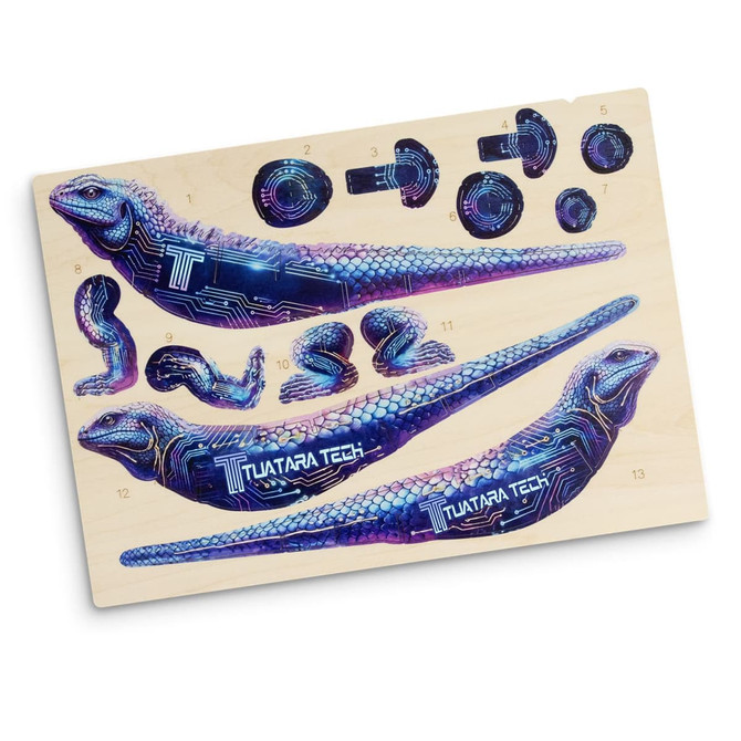 A vibrant Tuatara wooden model kit featuring intricate designs in blue and purple, showcasing multiple pieces on a wooden board.