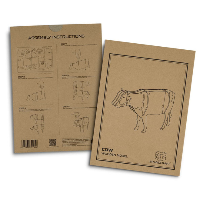 A wooden model kit portraying a cow, featuring assembly instructions on the packaging. The colours are neutral browns and tans.