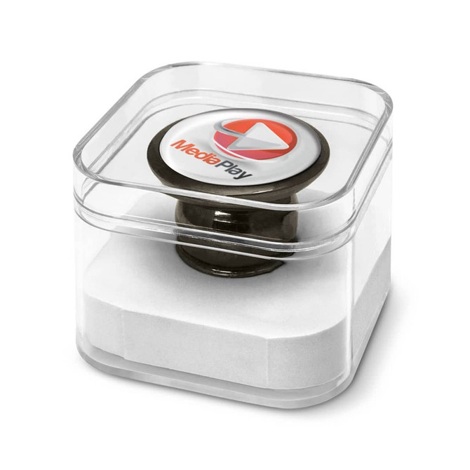 A magnetic phone holder in a clear box, featuring a round, black base and a circular top with a logo.