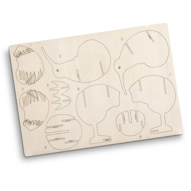 A wooden model kit featuring kiwi-shaped pieces with cut-out designs, presented on a light wood board.