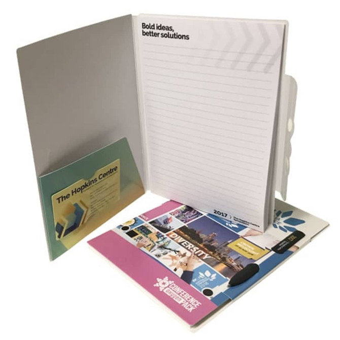 A grey conference pack with a notepad, a pocket for documents, and a pen. Features colourful promotional materials inside.