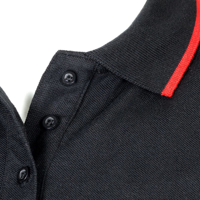 A black polo shirt with a red collar and button detail, featuring a logo on the left side.