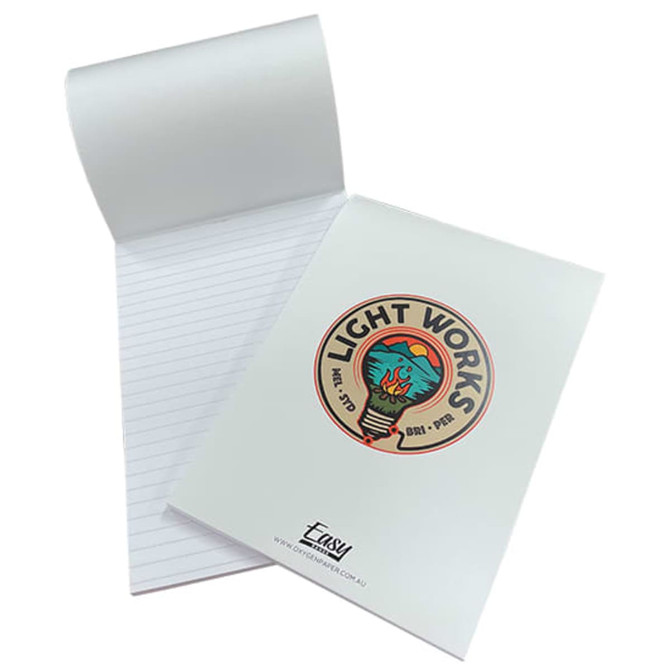 A white A5 notepad with lined pages, featuring a colourful logo on the cover and a wrap-over design.