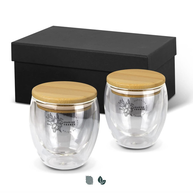 A drinkware set featuring two clear glass mugs with bamboo lids, presented in a black gift box.