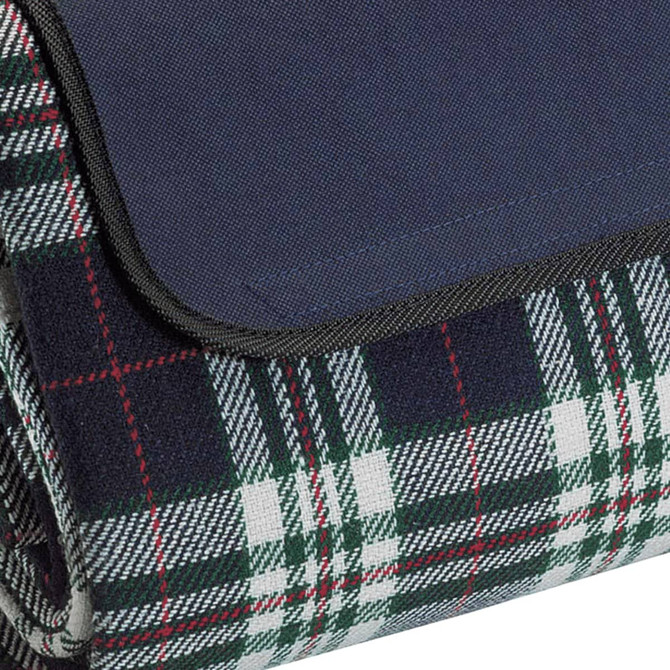 A rolled-up picnic rug featuring a navy top and a green and white tartan pattern on the underside.