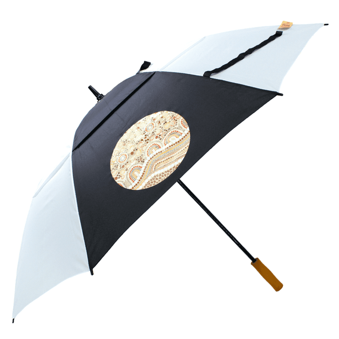 A black and white golf umbrella with a patterned circular design, featuring a wooden handle and a logo.