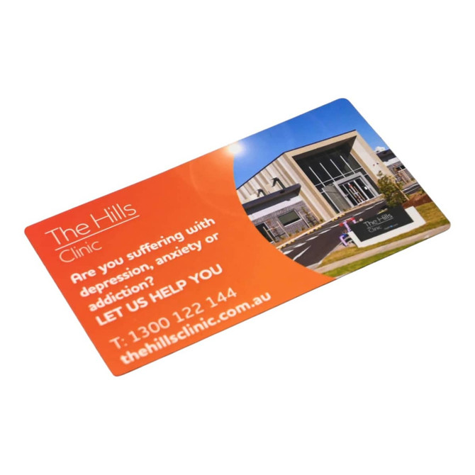 A rounded-corner fridge magnet featuring an orange and blue design with a modern building image.