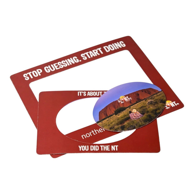 A magnetic photo frame in red featuring a circular cut-out and includes a printed photo.