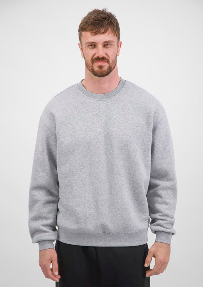 A men's crew sweatshirt in grey, featuring long sleeves and a classic fit, displayed by a model.