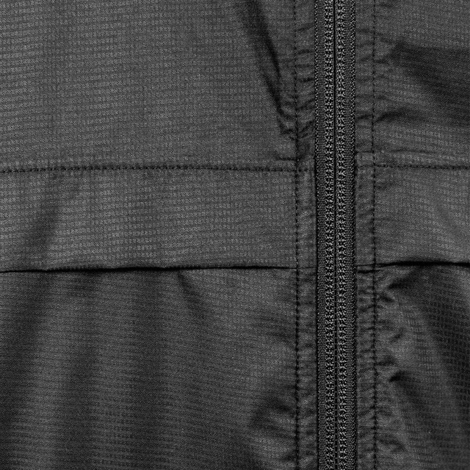 A close-up view of a black windbreaker jacket featuring visible stitching and a zipper. The fabric has a textured pattern.