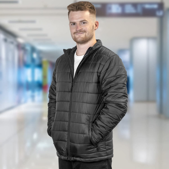 A unisex black puffer jacket with a zip front, featuring side pockets and a logo.