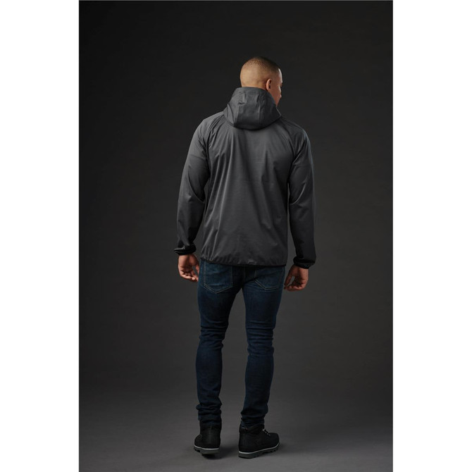A black men's softshell jacket with a hood, shown from the back, paired with dark jeans. Features branding.