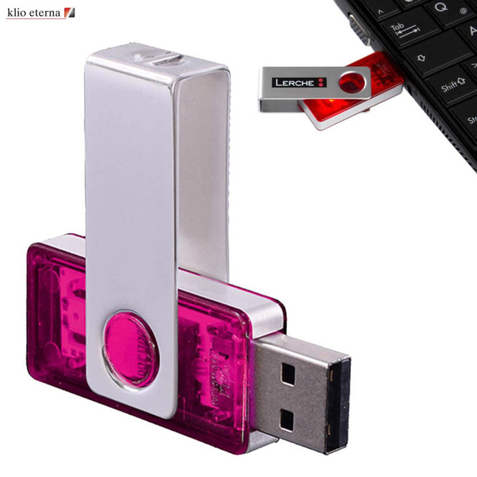 A silver and pink USB flash drive with a metal clip, featuring a logo and connected to a keyboard.