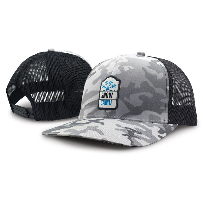 A trucker cap in grey snow camouflage with a black mesh back and a badge on the front.