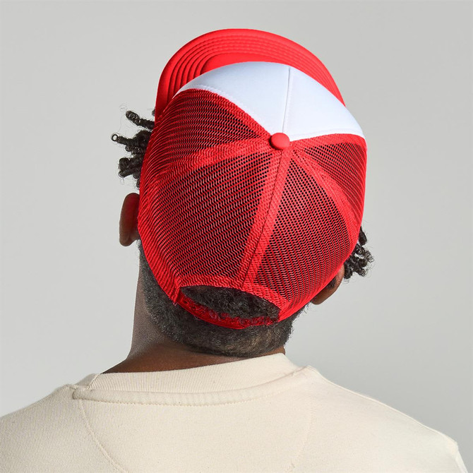 A red and white trucker cap featuring a mesh back and a logo at the rear.