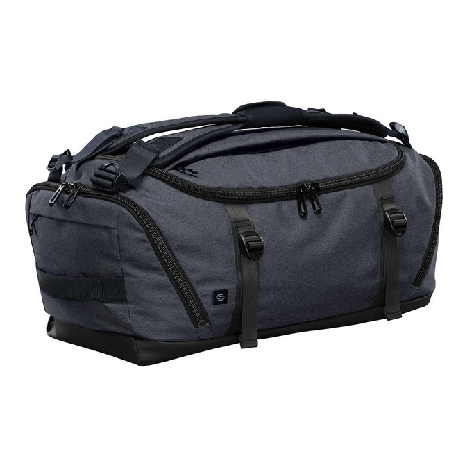 A dark grey duffel bag with black accents and multiple zippered compartments, featuring a logo on the side.