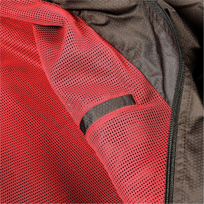 A close-up of a jacket's interior featuring black mesh fabric with red detailing and a zippered closure.