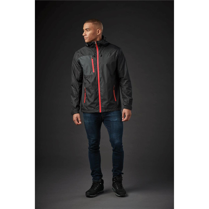 A man wearing a black rain jacket with grey and orange accents, featuring a hood and front pockets.