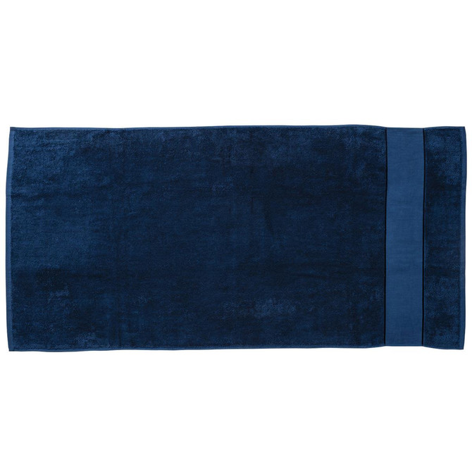 A deep navy blue beach towel featuring a smooth texture and a solid colour design, with a branded logo.