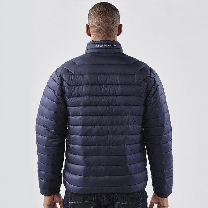 A navy men's puffer jacket with a quilted design and a collar. It features a logo on the back.