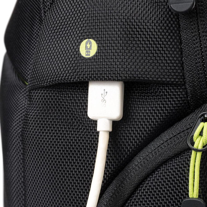 A close-up of the Swissdigital Java Backpack showcasing a USB port and cable against a black exterior with lime green accents.