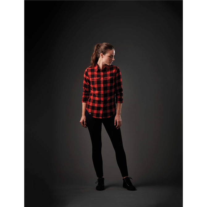 A red and black checkered button-up shirt worn by a woman, styled with black leggings. The shirt features a logo.
