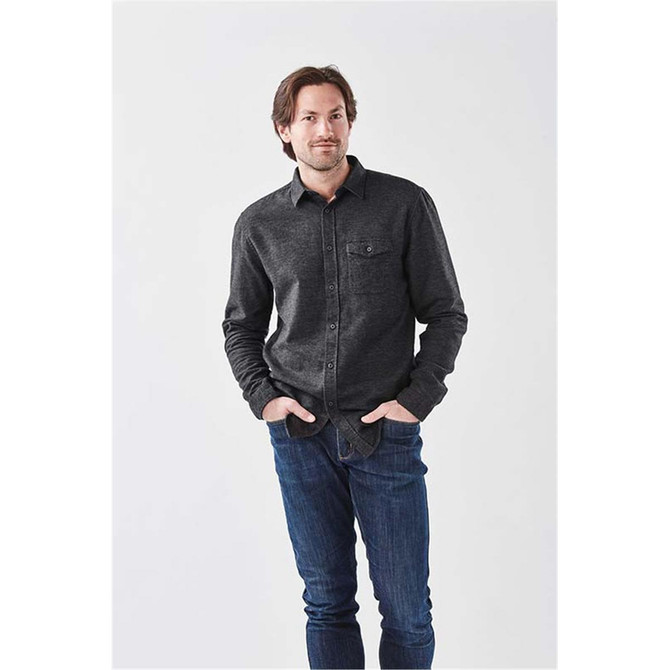 A men's long sleeve twill shirt in charcoal grey with a button-up front and a chest pocket, worn with jeans.