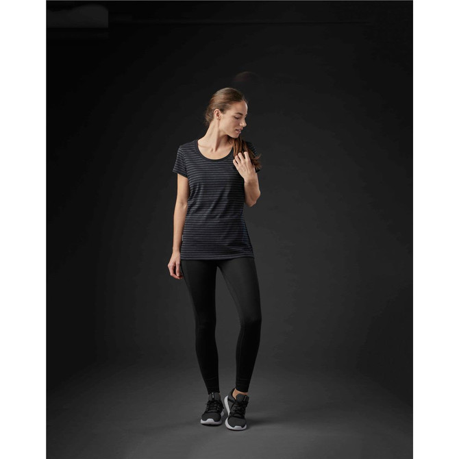 A fitted black and grey striped crew neck tee worn with black leggings, featuring a branding logo.