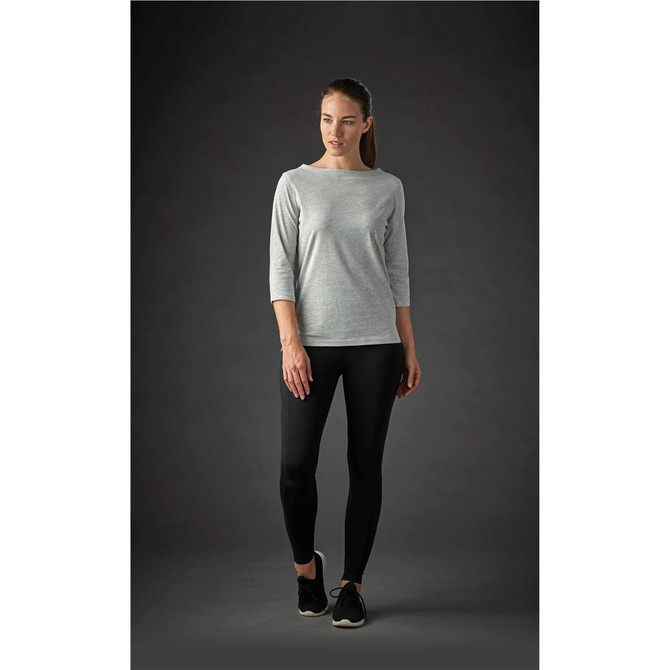 A grey women's 3/4 sleeve tee paired with black leggings, featuring a subtle logo.