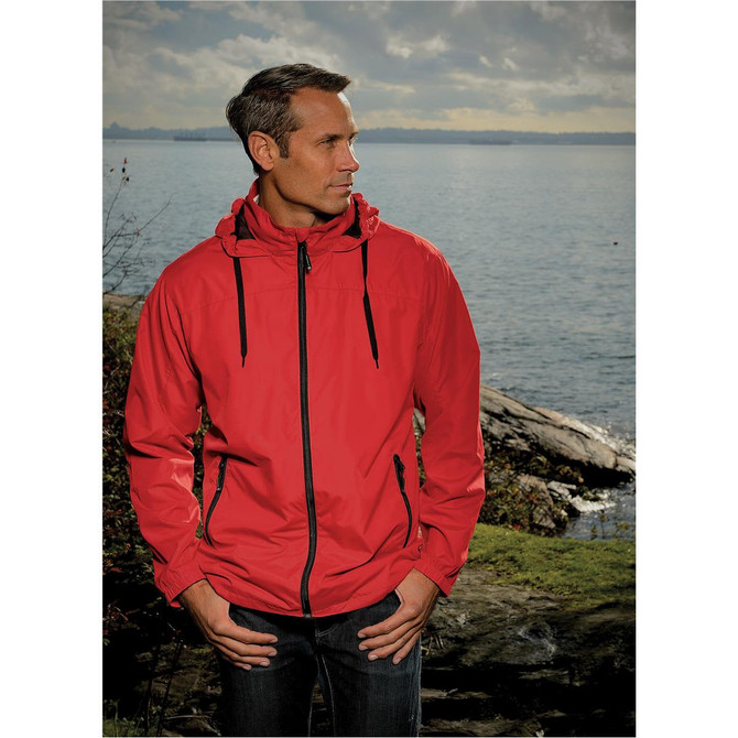 A red rain jacket with a hood, featuring black accents and zippers, worn by a man near a lake.