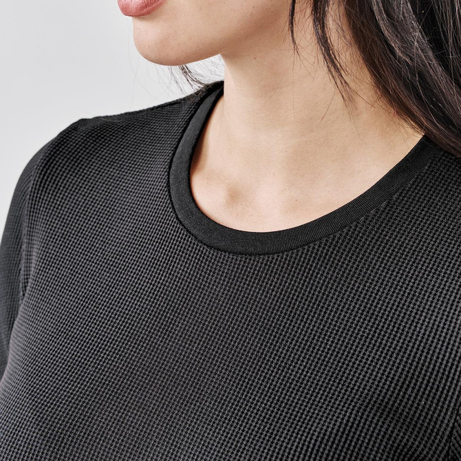 A close-up of a black crew neck shirt featuring a textured fabric and a round neckline.