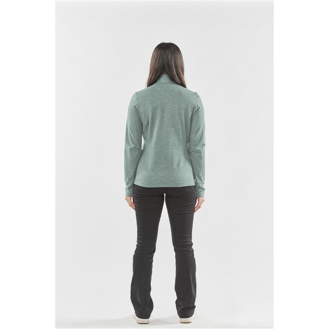 A back view of a women's performance jacket in a soft green colour, paired with black pants. The jacket features a logo.