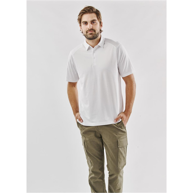 A white men's polo shirt worn with olive green cargo trousers, featuring a logo on the chest.