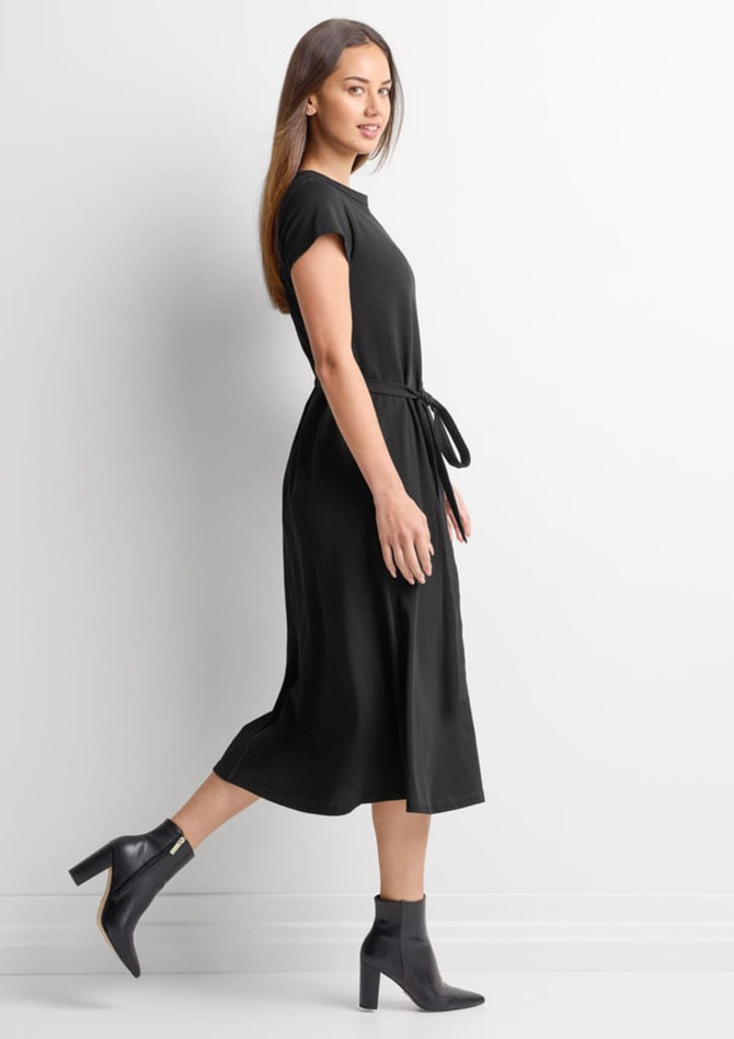 A black midi dress with short sleeves and a tied waist, featuring a model walking in profile.