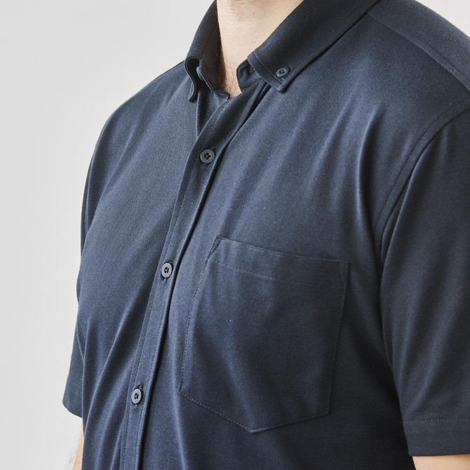 A navy short sleeve button-up shirt featuring a chest pocket and a logo.