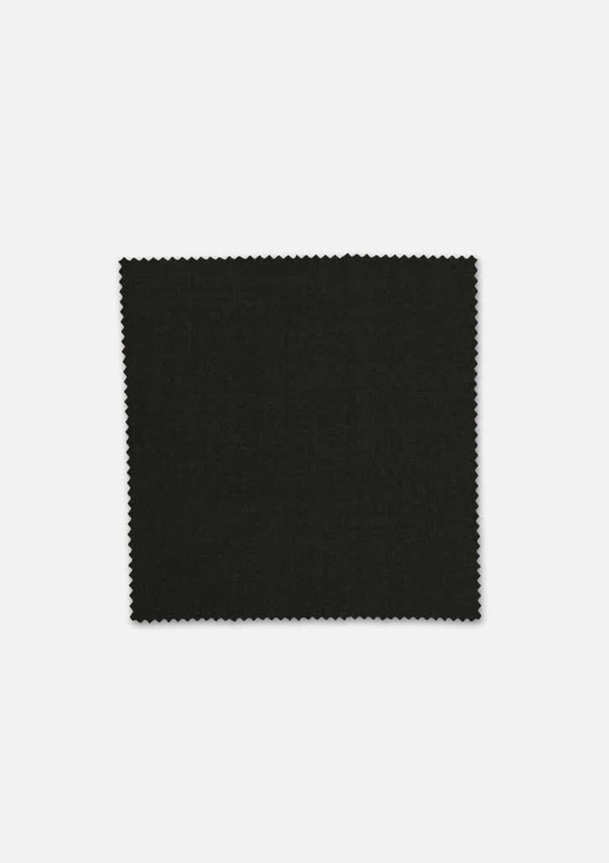 A square swatch of dark green wool fabric with a textured finish and a scalloped edge. It features a branding logo.