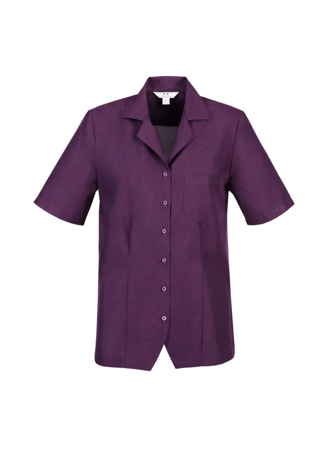 A short-sleeved overblouse in a rich purple colour with a button front and a pocket on the left chest.