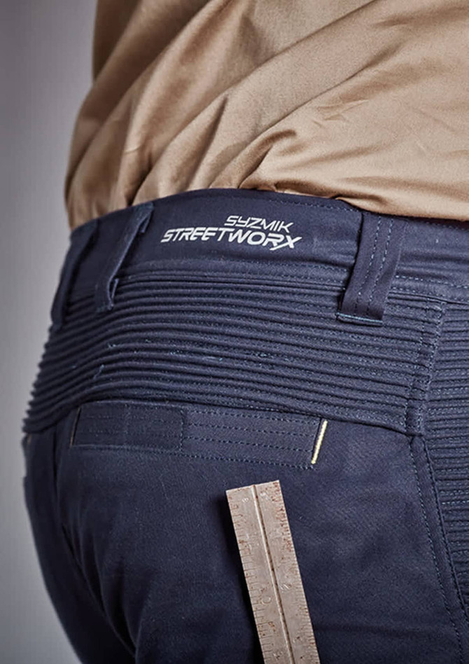 A close-up of navy shorts featuring a branded waistband and a ruler for measuring, highlighting the fabric's texture.