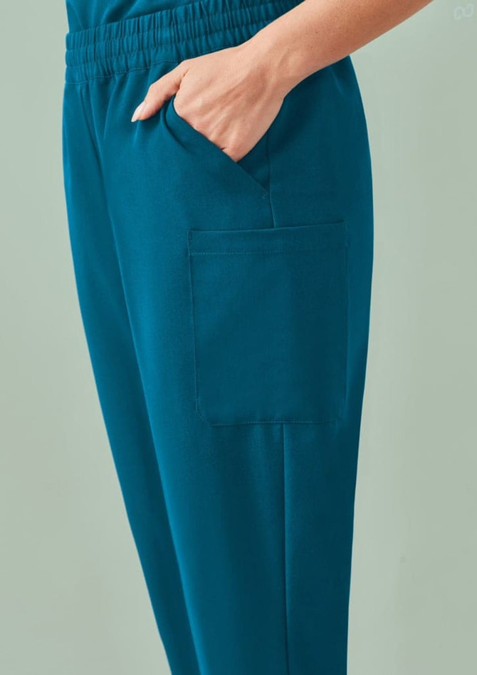 A teal women's jogger scrub pant featuring an elastic waistband and a side pocket.