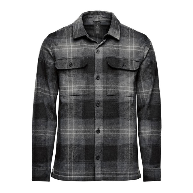 A men's shacket in a black and grey Highland plaid pattern, featuring two chest pockets and long sleeves.
