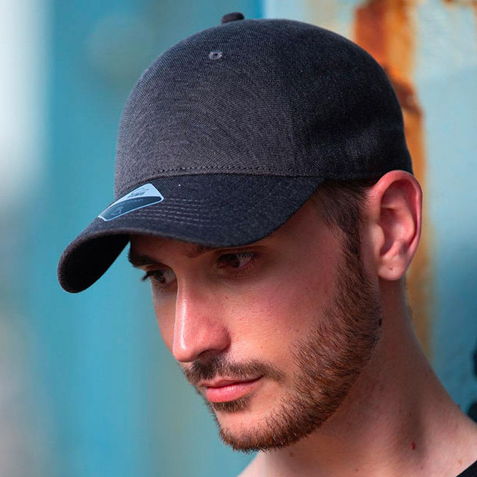 A dark grey cap with a curved brim and a logo on the front, worn by a male model.
