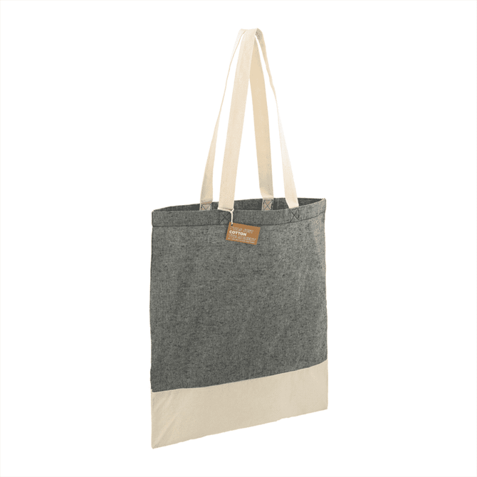 A recycled cotton twill tote bag in grey with a cream base and two sturdy handles. Features a logo tag.