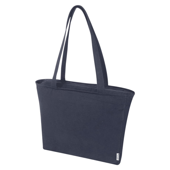 A navy blue zip tote bag with two handles and a logo, made from recycled materials.